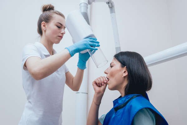 Radiologist taking patients' dental intraoral X-ray